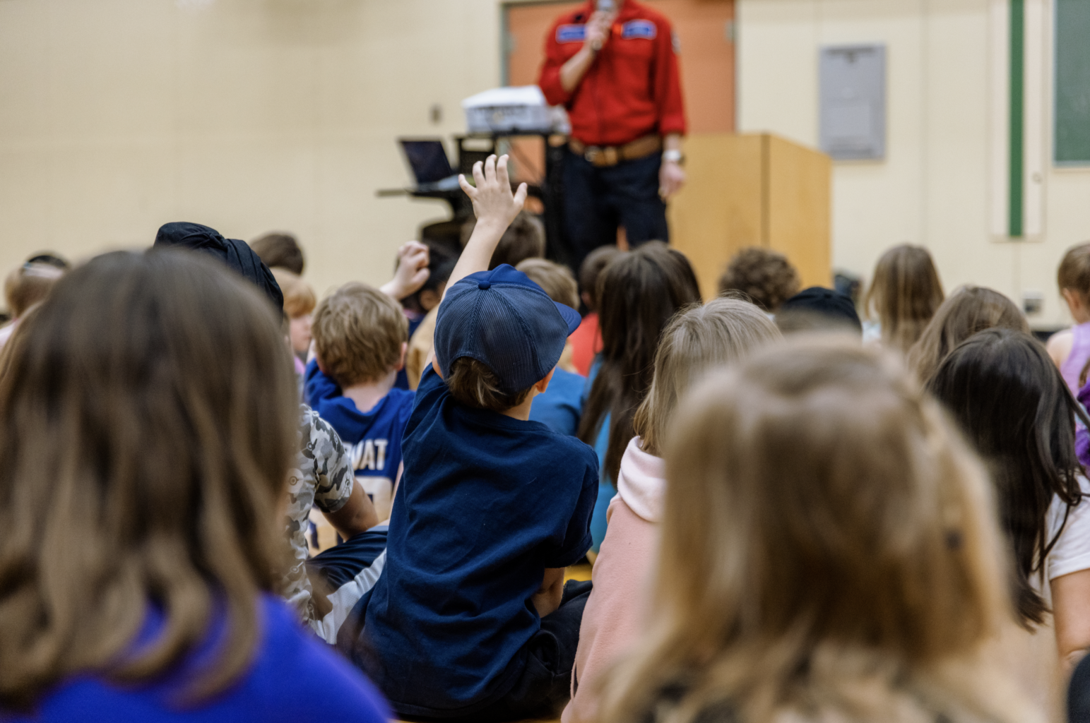 Woman speaking to a group of kids